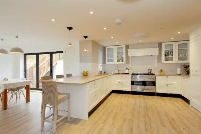 Κομψή και ευρύχωρη κουζίνα που προτιμήθηκε πάγκος-μπαρ, αντί τραπεζαρίας.