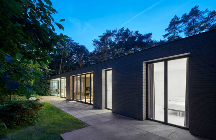 νυχτερινή άποψη βίλα με γυάλινους τοίχους